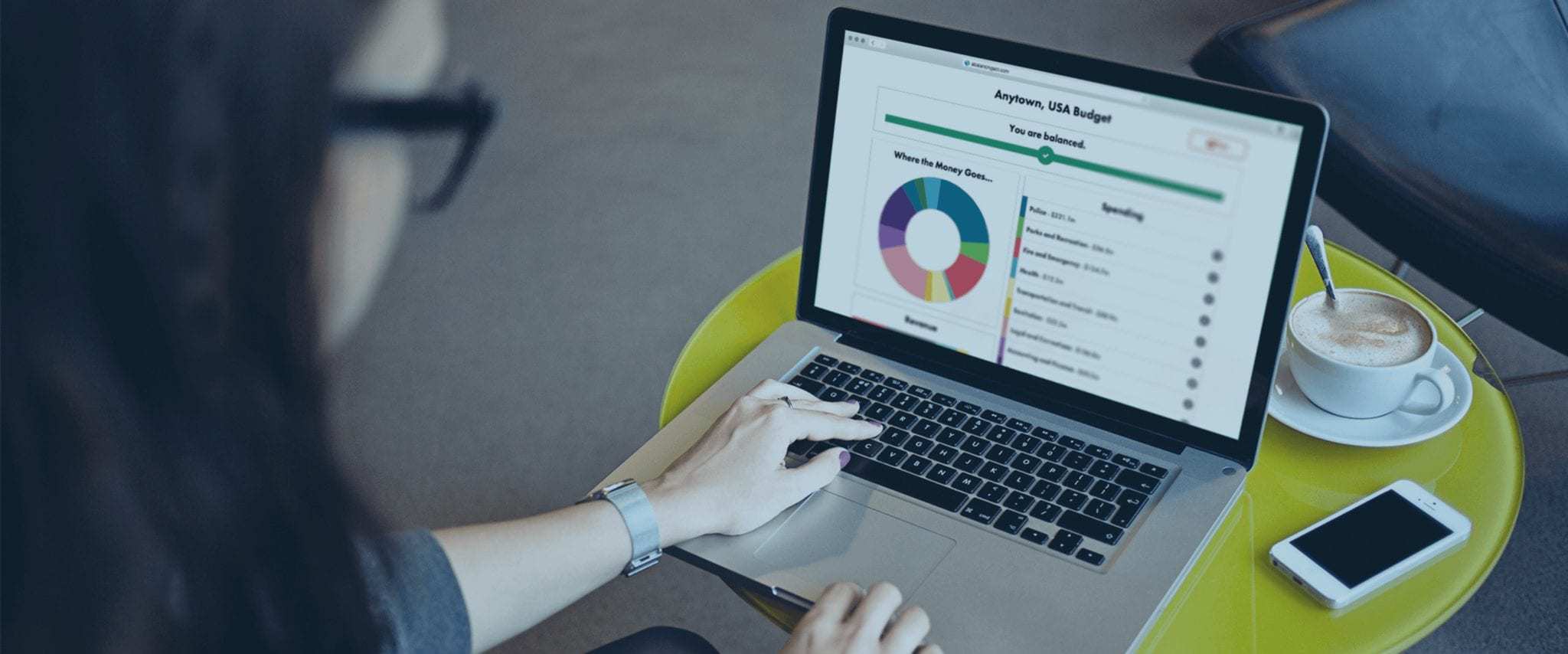 A woman accesses the Balancing Act platform website on a laptop