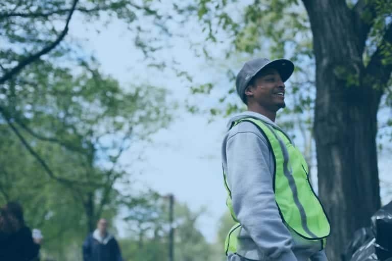 A working in a reflective vest working outdoors.