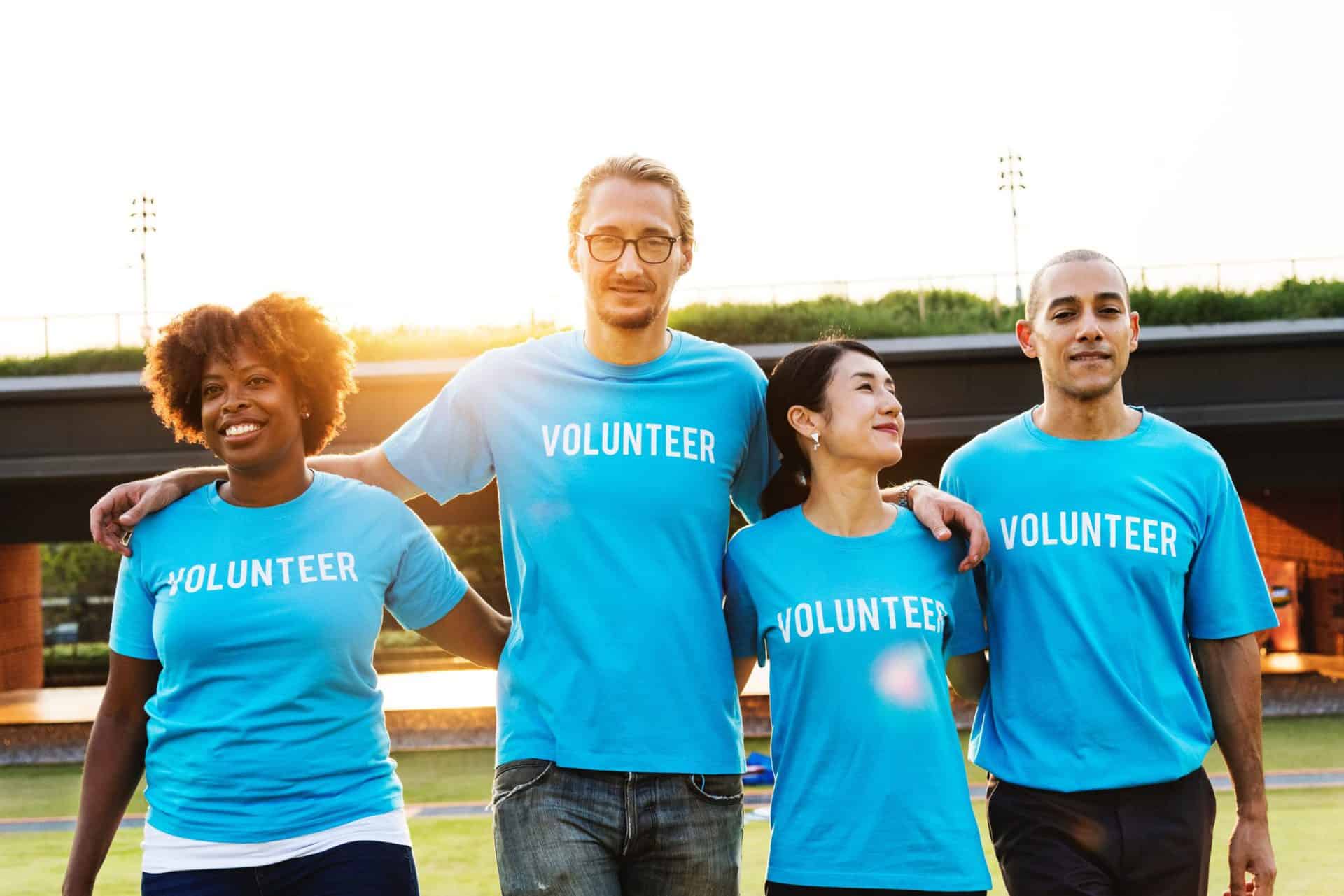 A diverse group of people wearing Volunteer shirts.