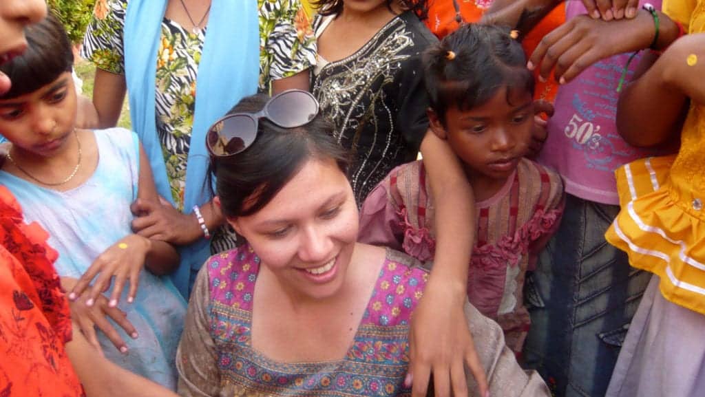 CauseLabs CEO, Sheryle Gillihan, is surrounded by children while visiting an orphanage in India with a social impact company.