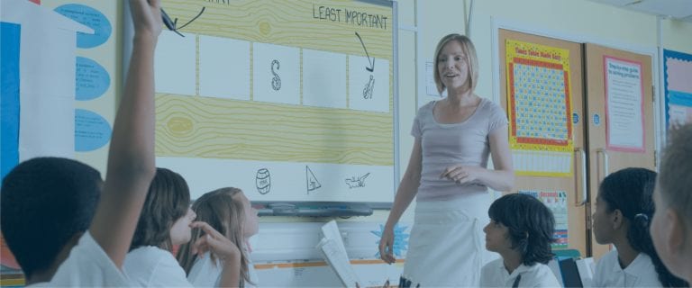 A teacher answers a question from a student while using SmartPath