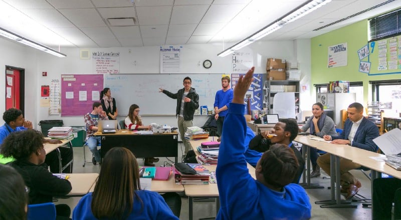 A classroom with students and teacher engaged in learning.