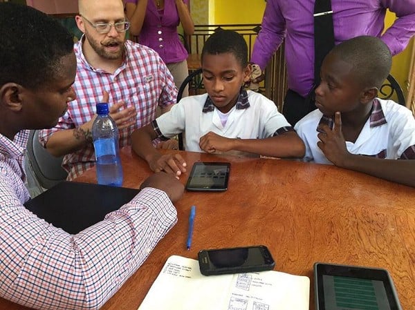 CauseLabs alumnus Brian Vanaski tests a clickable InVision prototype for a children's library app in Haiti.