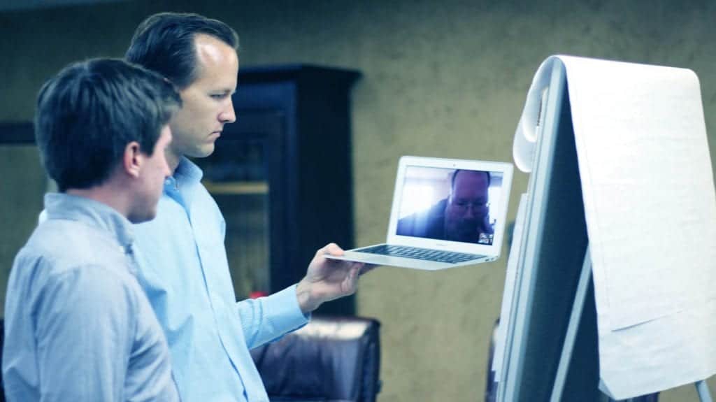 Two men video conferencing during an HCD workshop