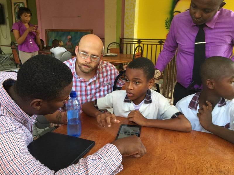 CauseLabs alumnus Brian Vanaski tests a clickable InVision prototype for a children's library app in Haiti.