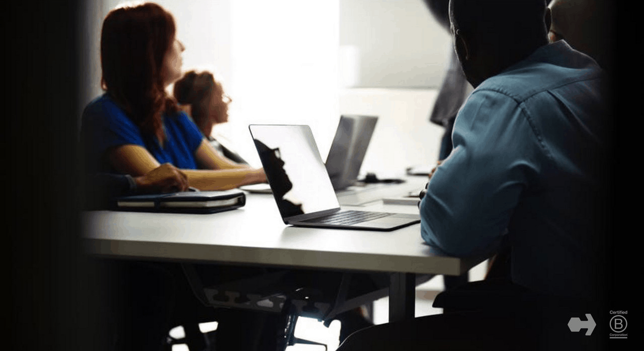 A diverse group of people on computers.