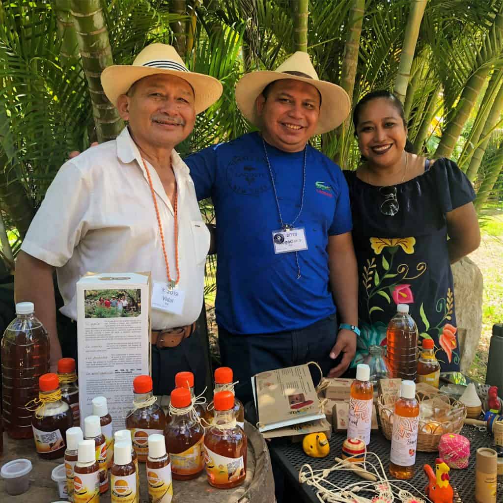 3 artisans showing their product in the market