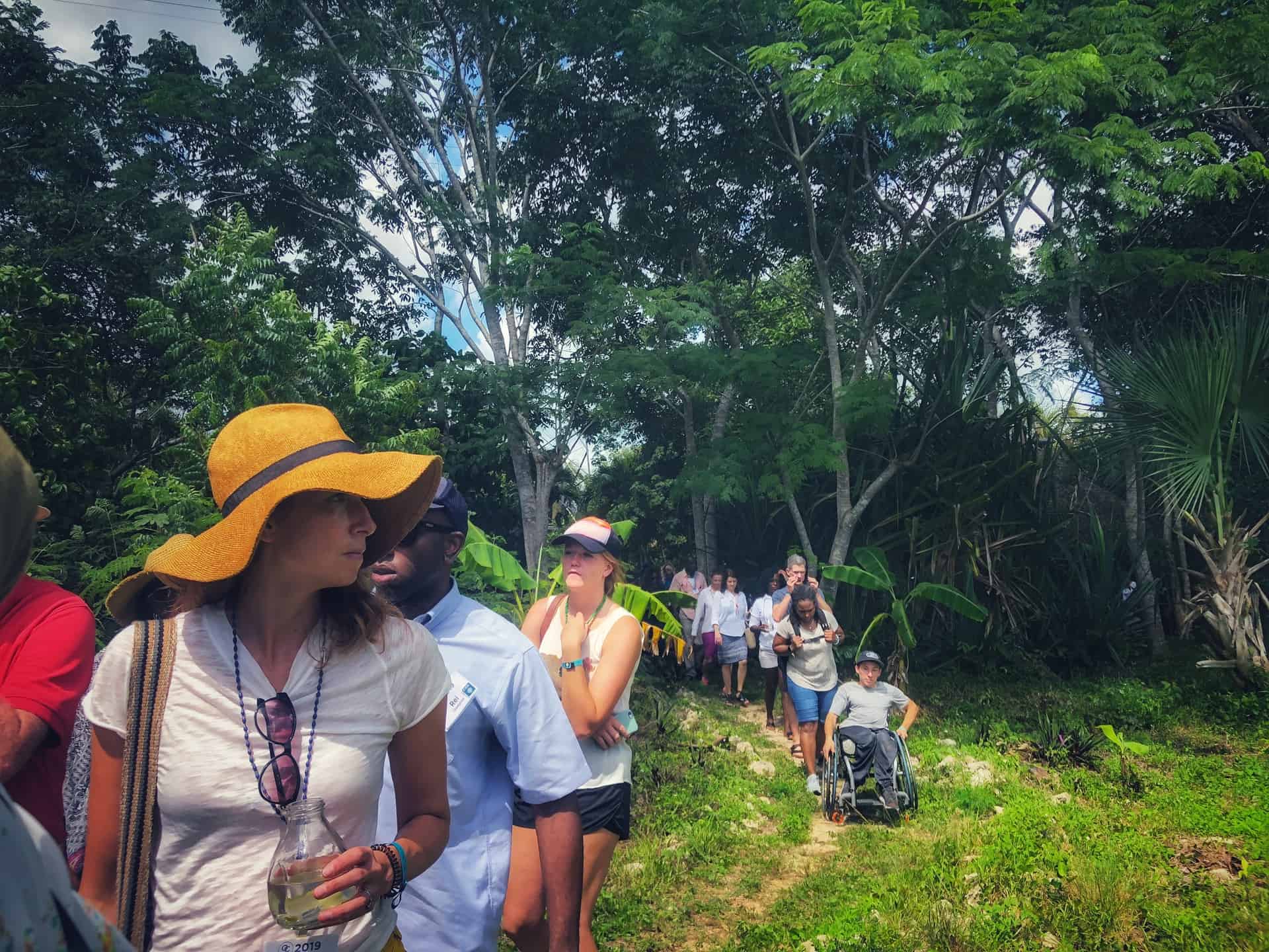 OC attendees traveling single file on a jungle-like path.