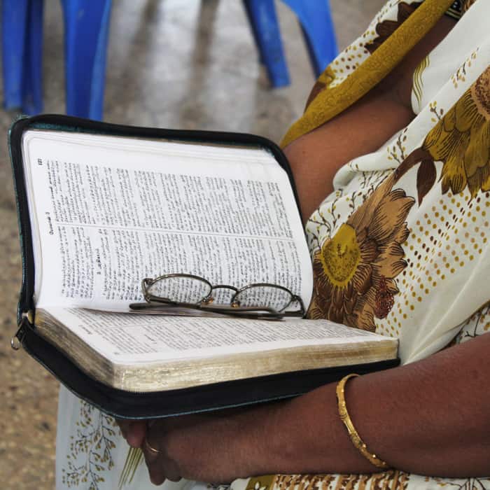 Woman holding a translated Bible