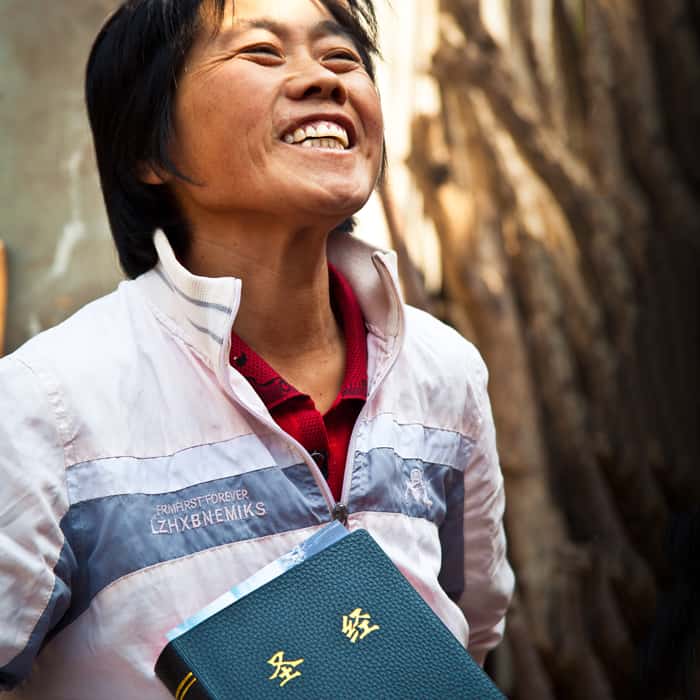 A happy person with a Bible in hand