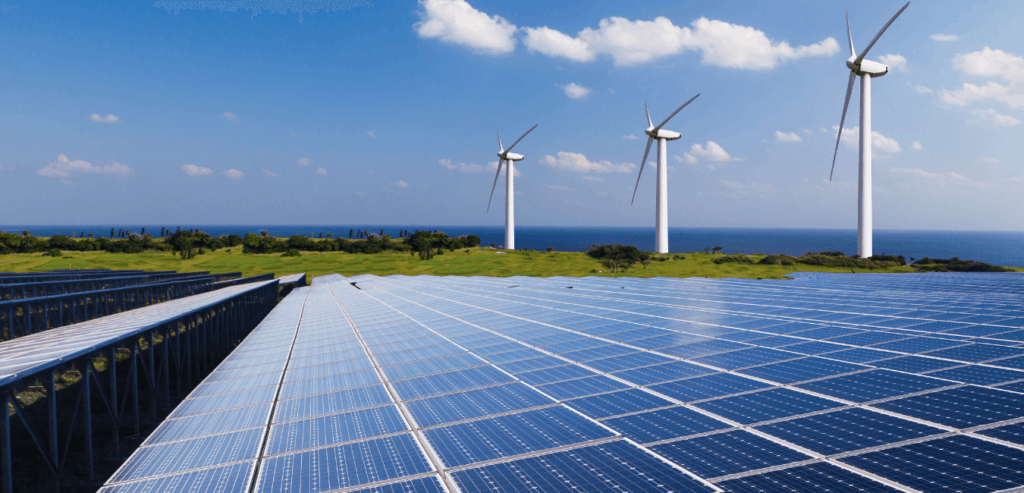 A blue sky with windmills and solar panels