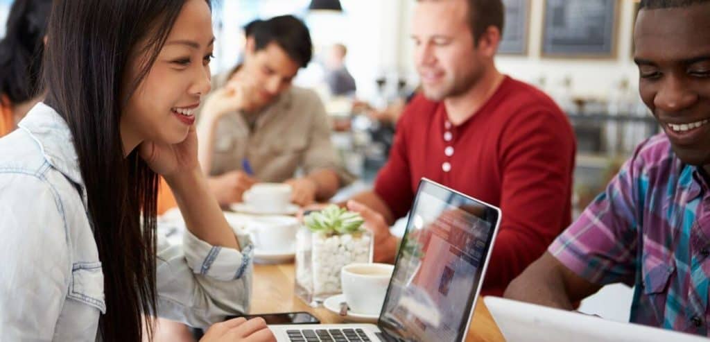 A cosmopolitan group of young people in a co-working space