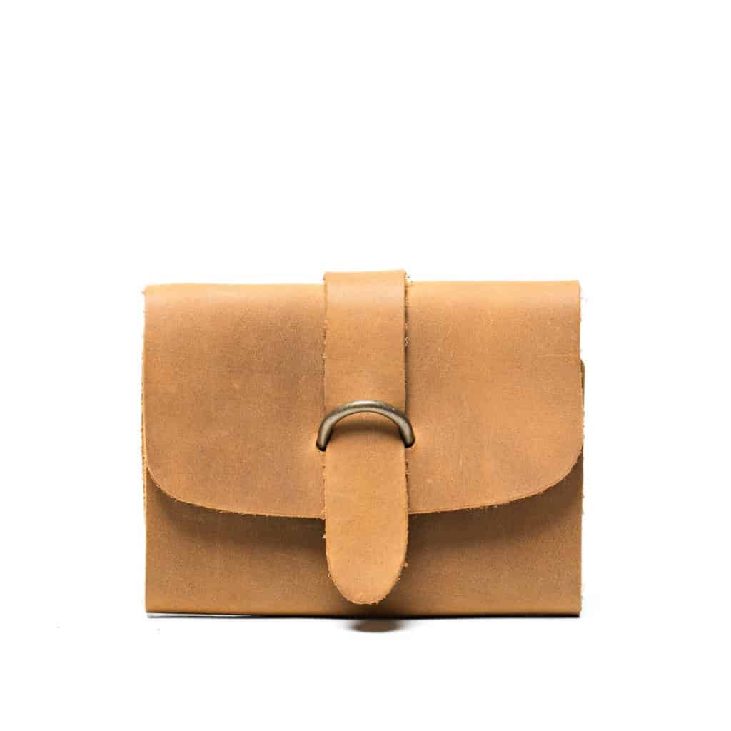 A simple brown leather looking bag with a metal in the front from Love 41