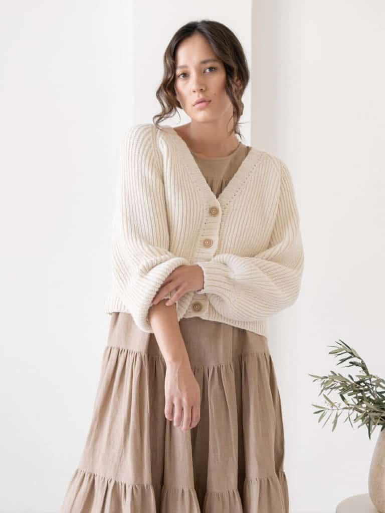 Women wearing a stylish white cardigan and brown skirt from LAUDE the Label