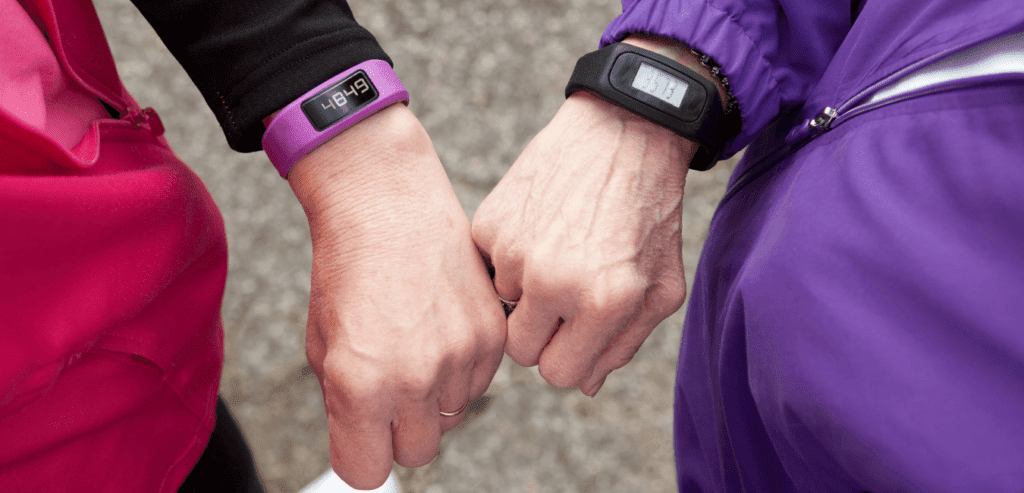 Couple hiking wearing jacket outdoors wearing a fitness band