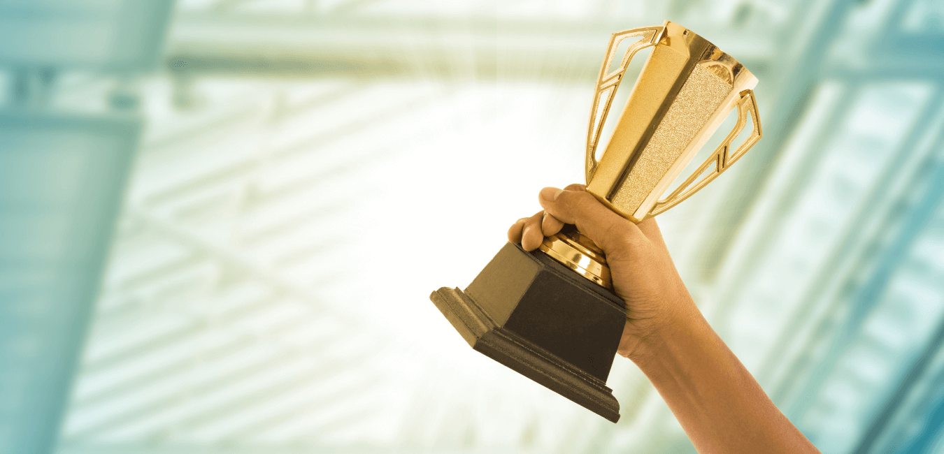 Business person wins award and holding a trophy