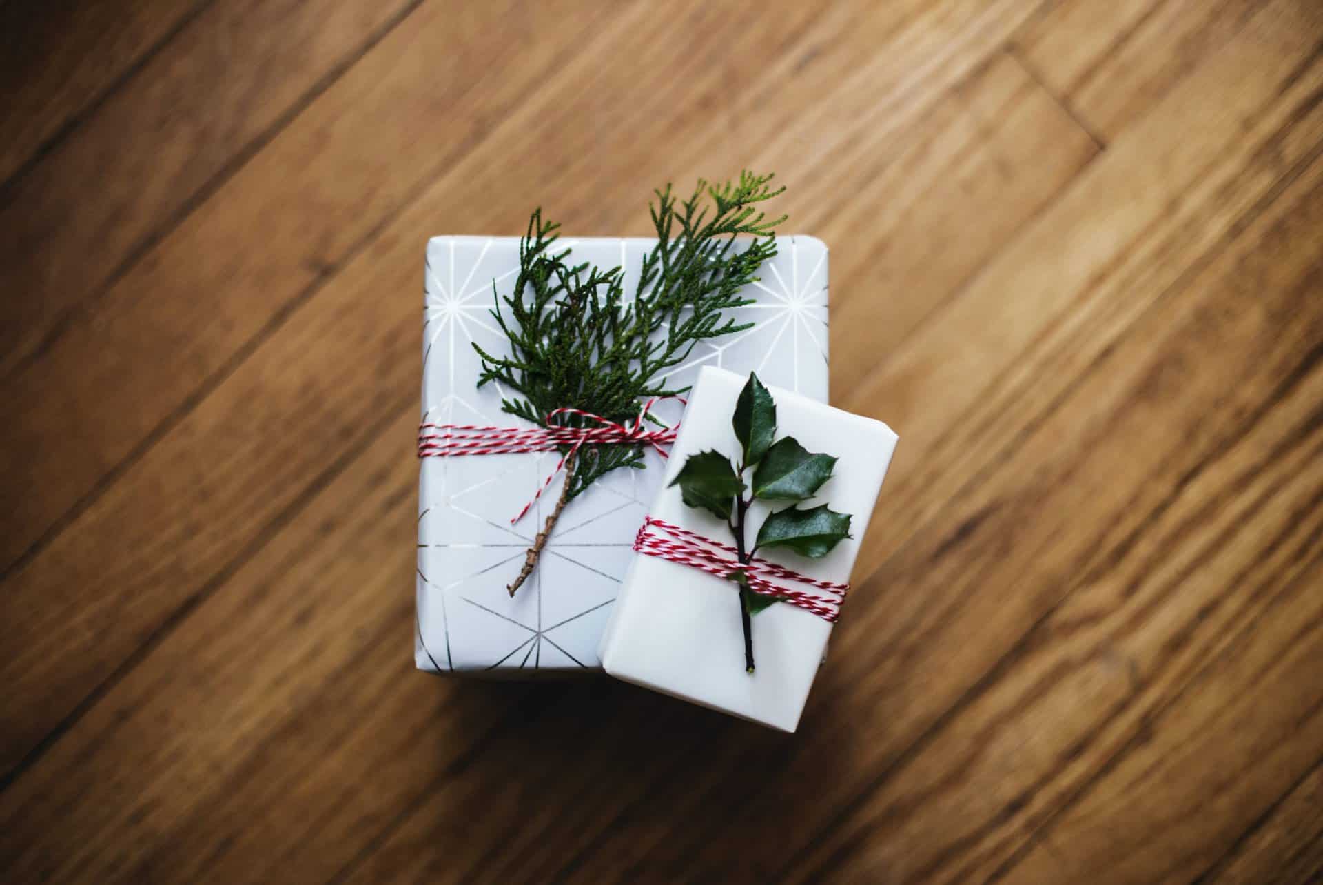 Two wrapped packages with greenery on top