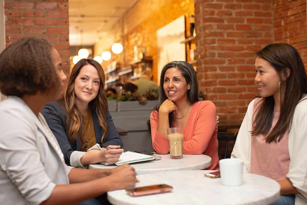 Four women sitting around a table