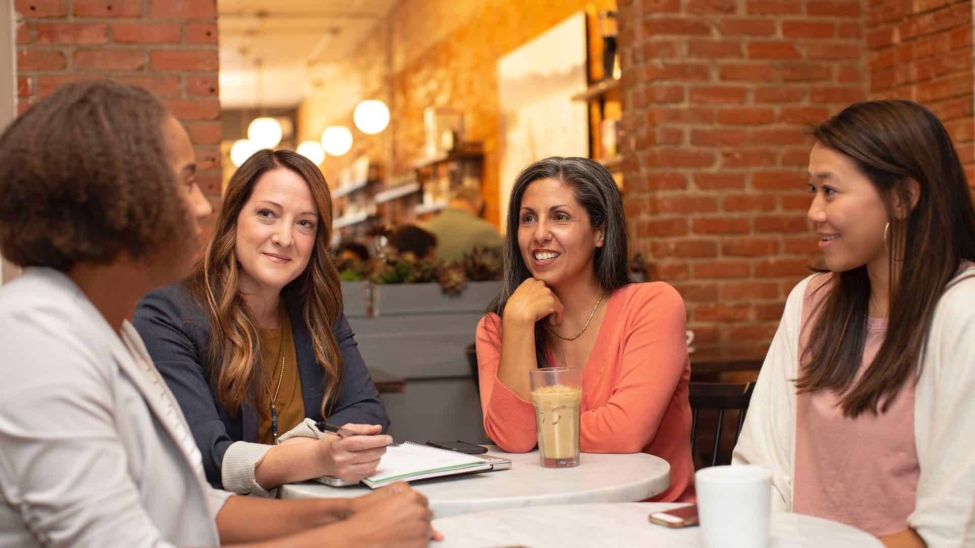 Four women sitting around a table