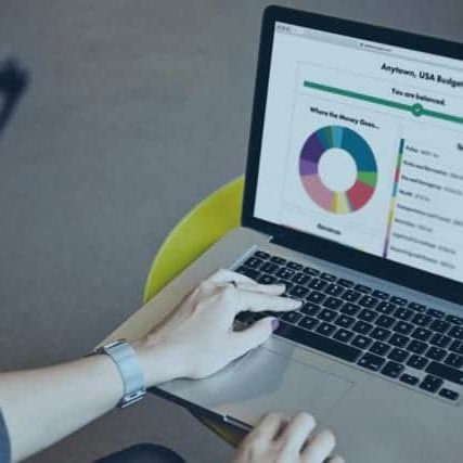 A woman accesses the Balancing Act platform website on a laptop