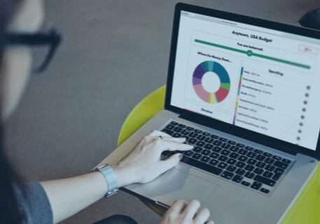 A woman accesses the Balancing Act platform website on a laptop