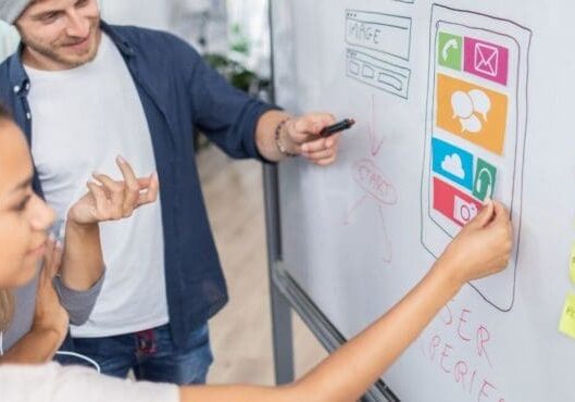 A team working on website strategy on a whiteboard