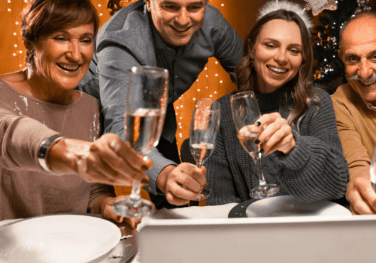 Family vide calling using laptop celebrating new years eve