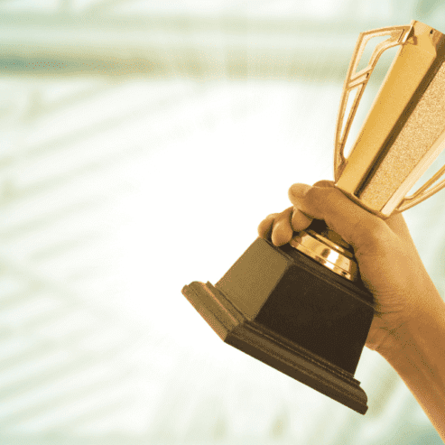 Business person wins award and holding a trophy