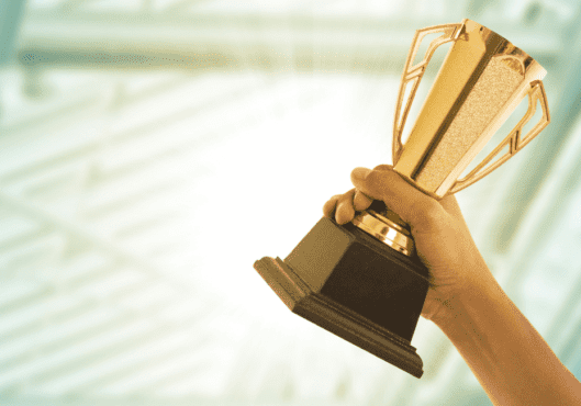 Business person wins award and holding a trophy