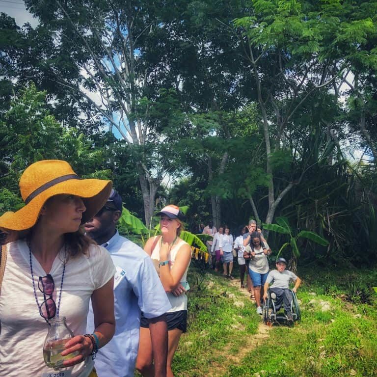 OC attendees traveling single file on a jungle-like path.