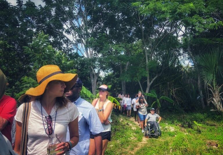 OC attendees traveling single file on a jungle-like path.