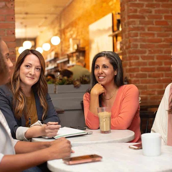 Four women sitting around a table