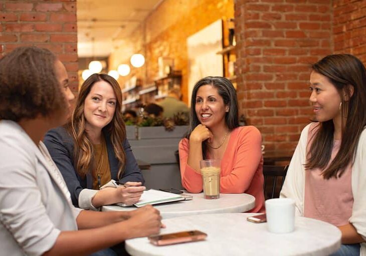 Four women sitting around a table