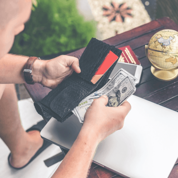 A person counting the money in their wallet.