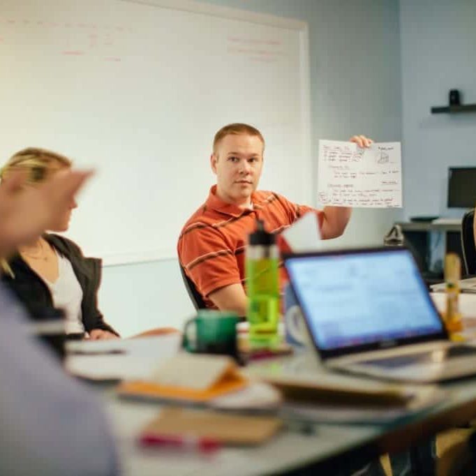 A man holds up a diagram during a CauseLabs strategic workshop.