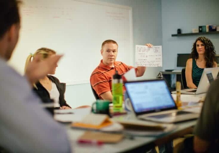 A man holds up a diagram during a CauseLabs strategic workshop.