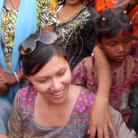 CauseLabs CEO, Sheryle Gillihan, is surrounded by children while visiting an orphanage in India with a social impact company.