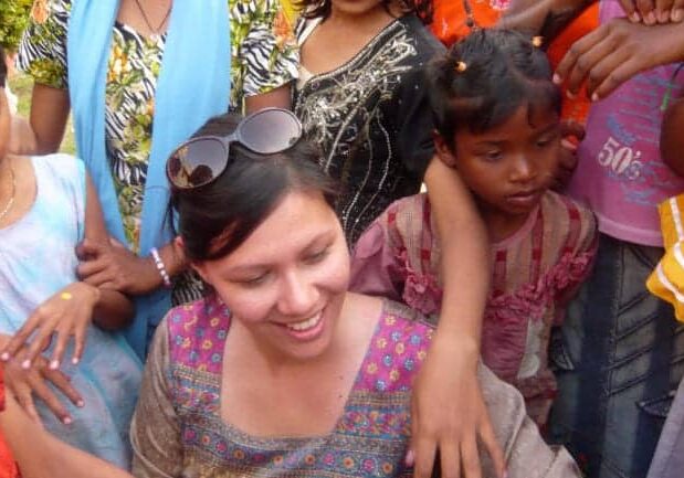 CauseLabs CEO, Sheryle Gillihan, is surrounded by children while visiting an orphanage in India with a social impact company.